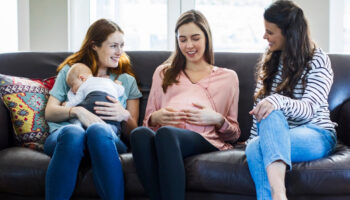 pregnant-woman-with-friends-and-baby-boy-on-sofa-picture-1000px